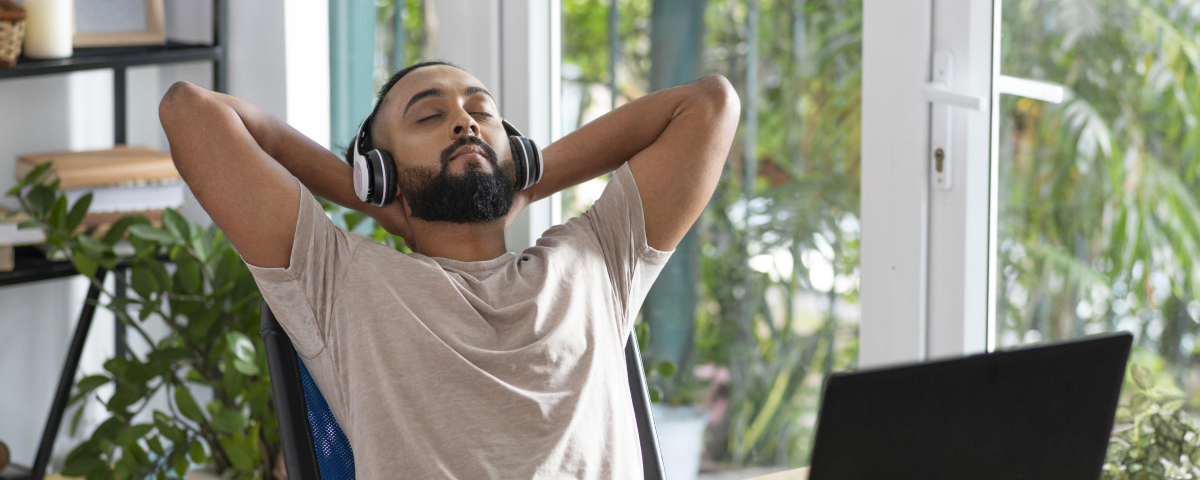 Man sitting back with eyes closed and headphones on
