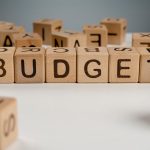 Wooden cubes spelling 'Budget'.