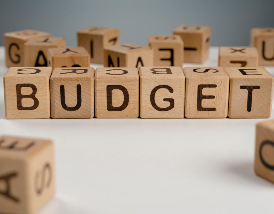 Wooden cubes spelling 'Budget'.