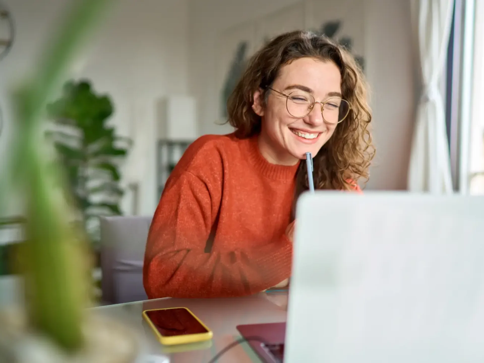 Woman smiling while working at her laptop