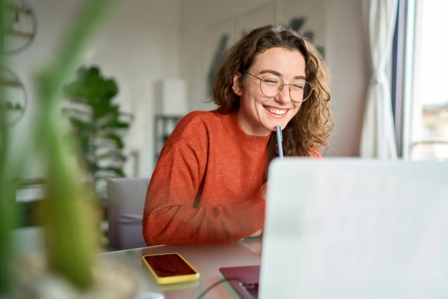 Woman smiling while working at her laptop