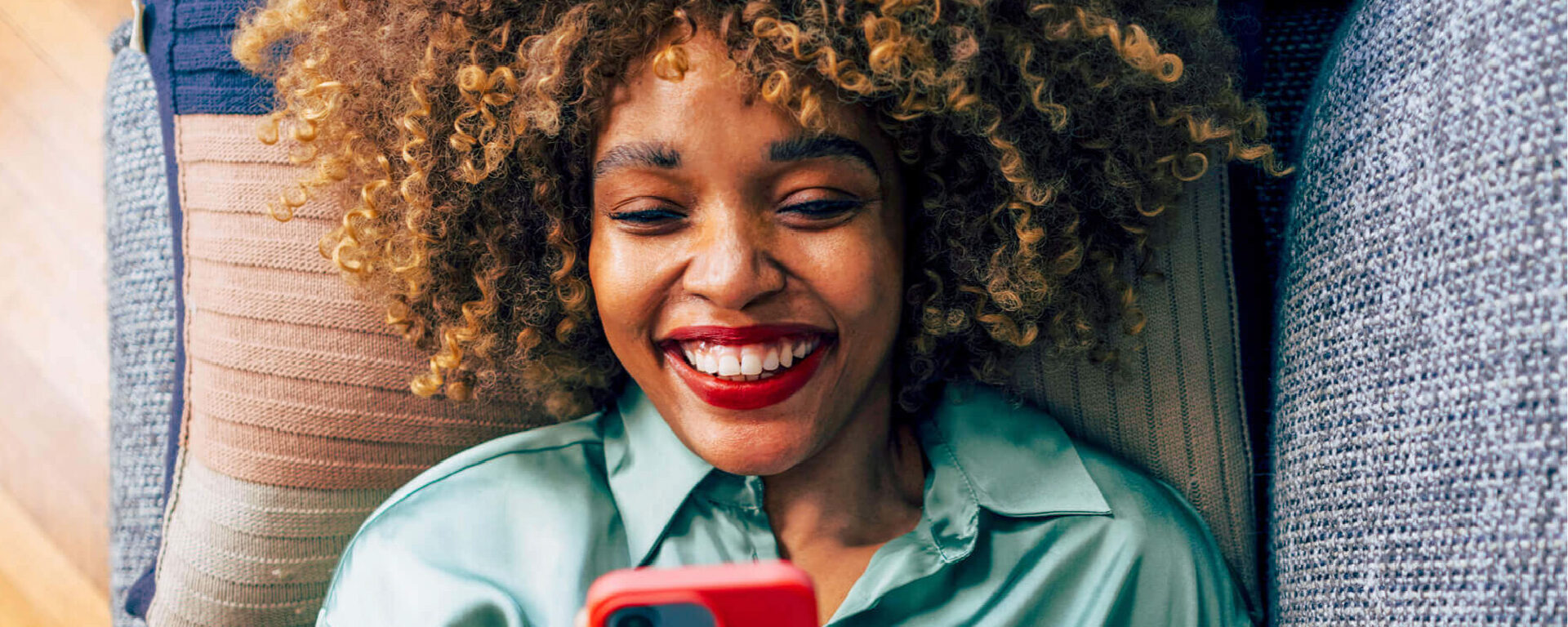 Woman smiling while holding her phone