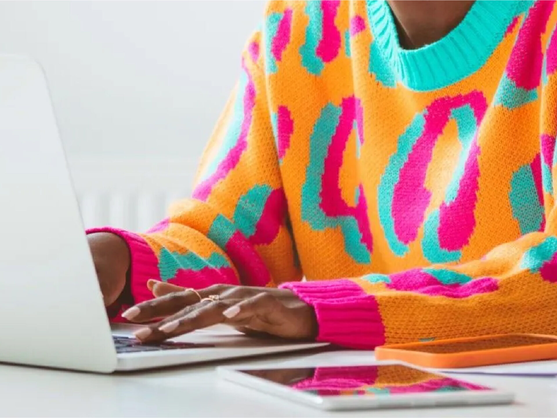 Hands typing on a laptop