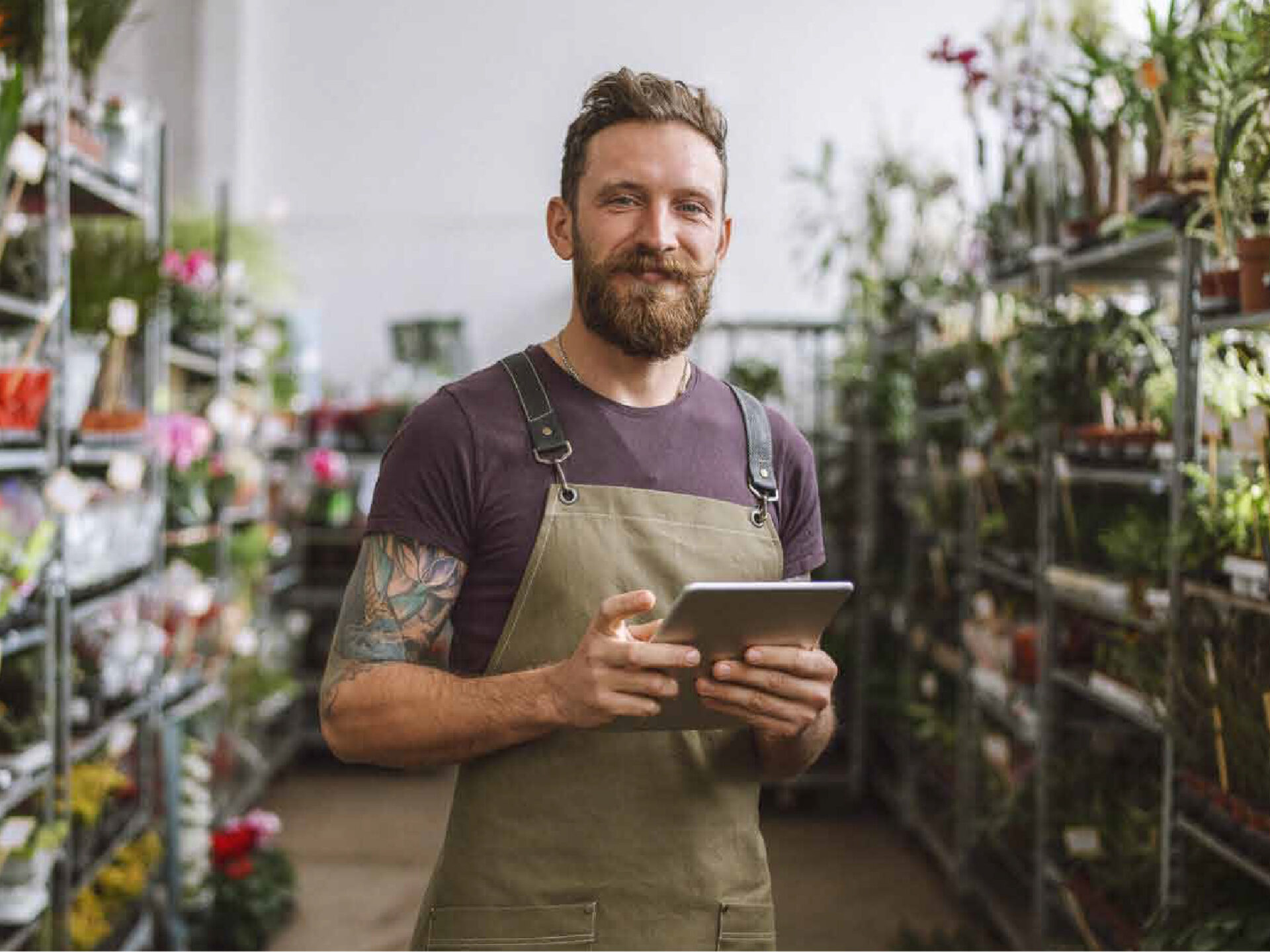 Man using a tablet in a garden centre