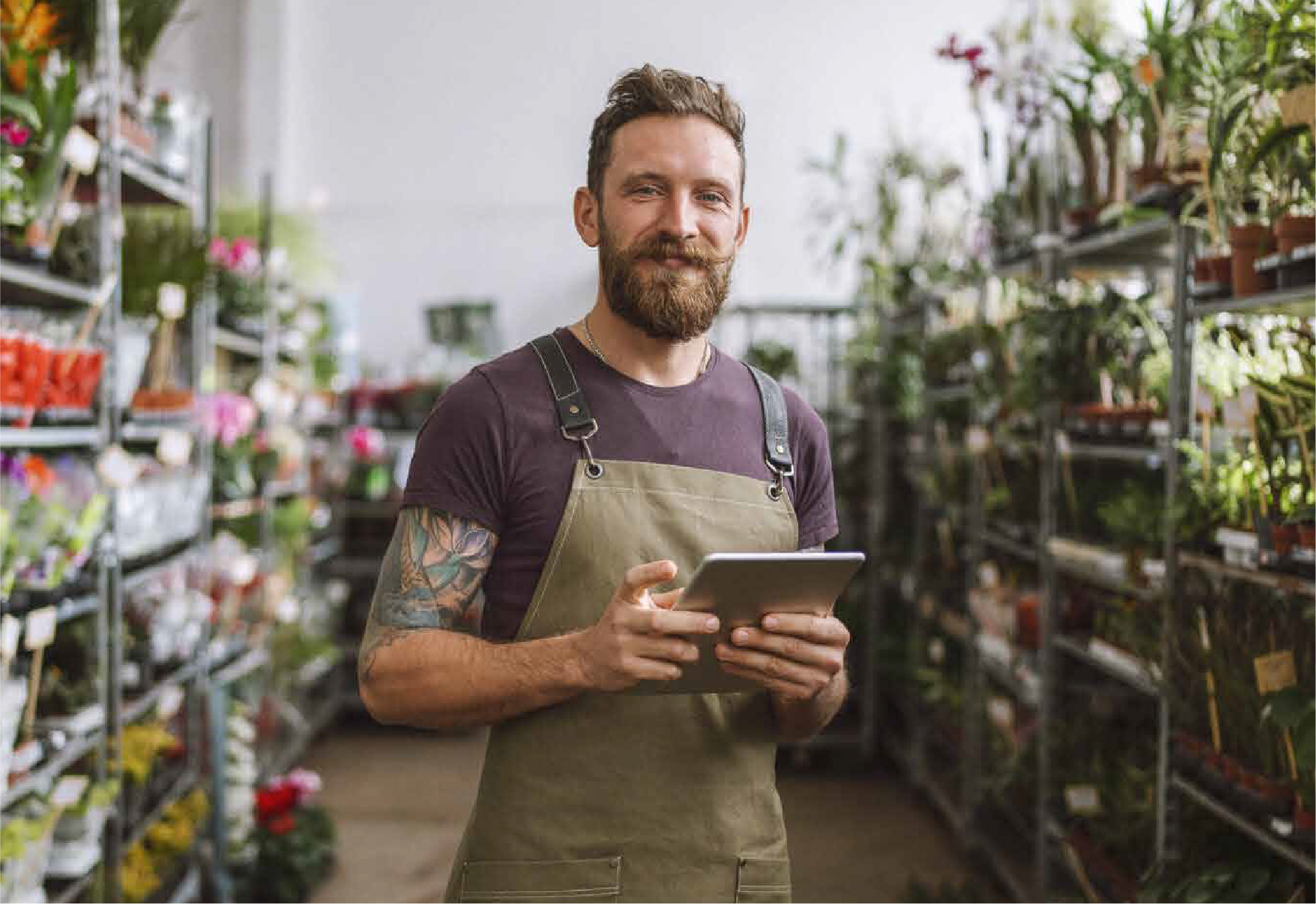 Man using a tablet in a garden centre