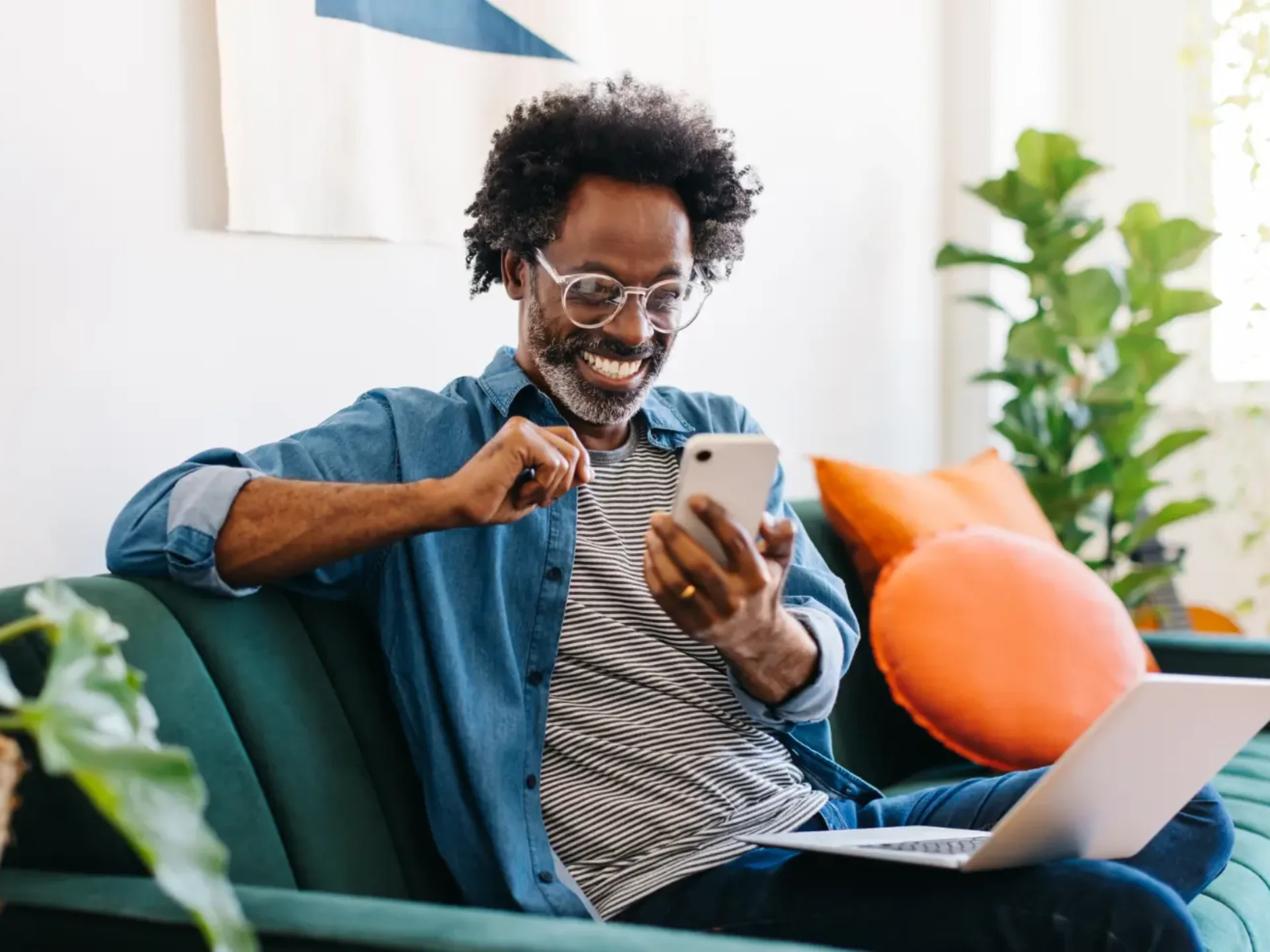 Man working on a laptop while relaxing on a sofa