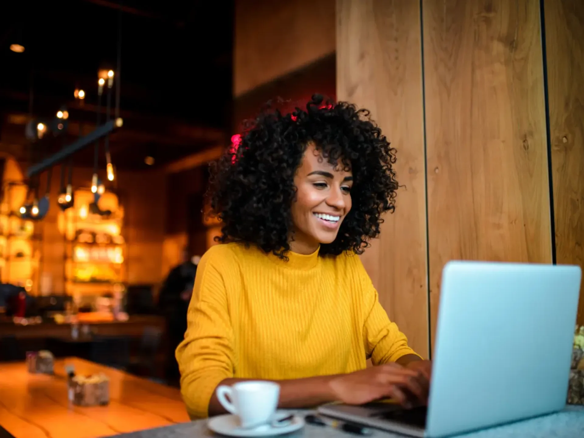 Woman working at a laptop in a café