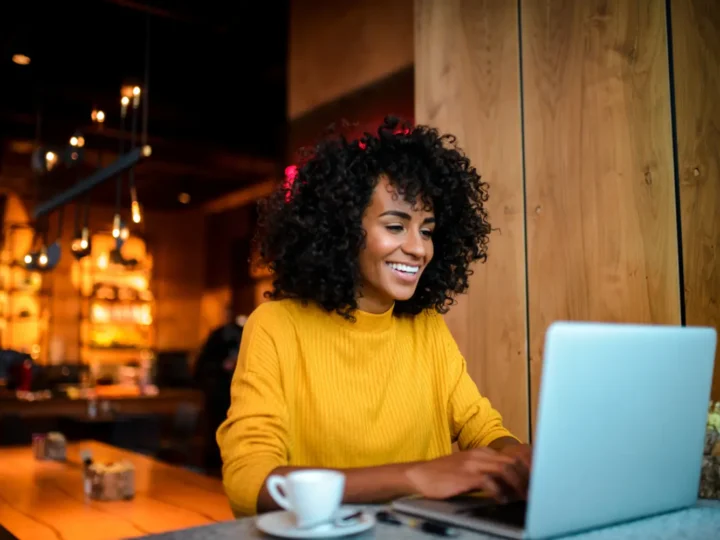 Woman working at a laptop in a café
