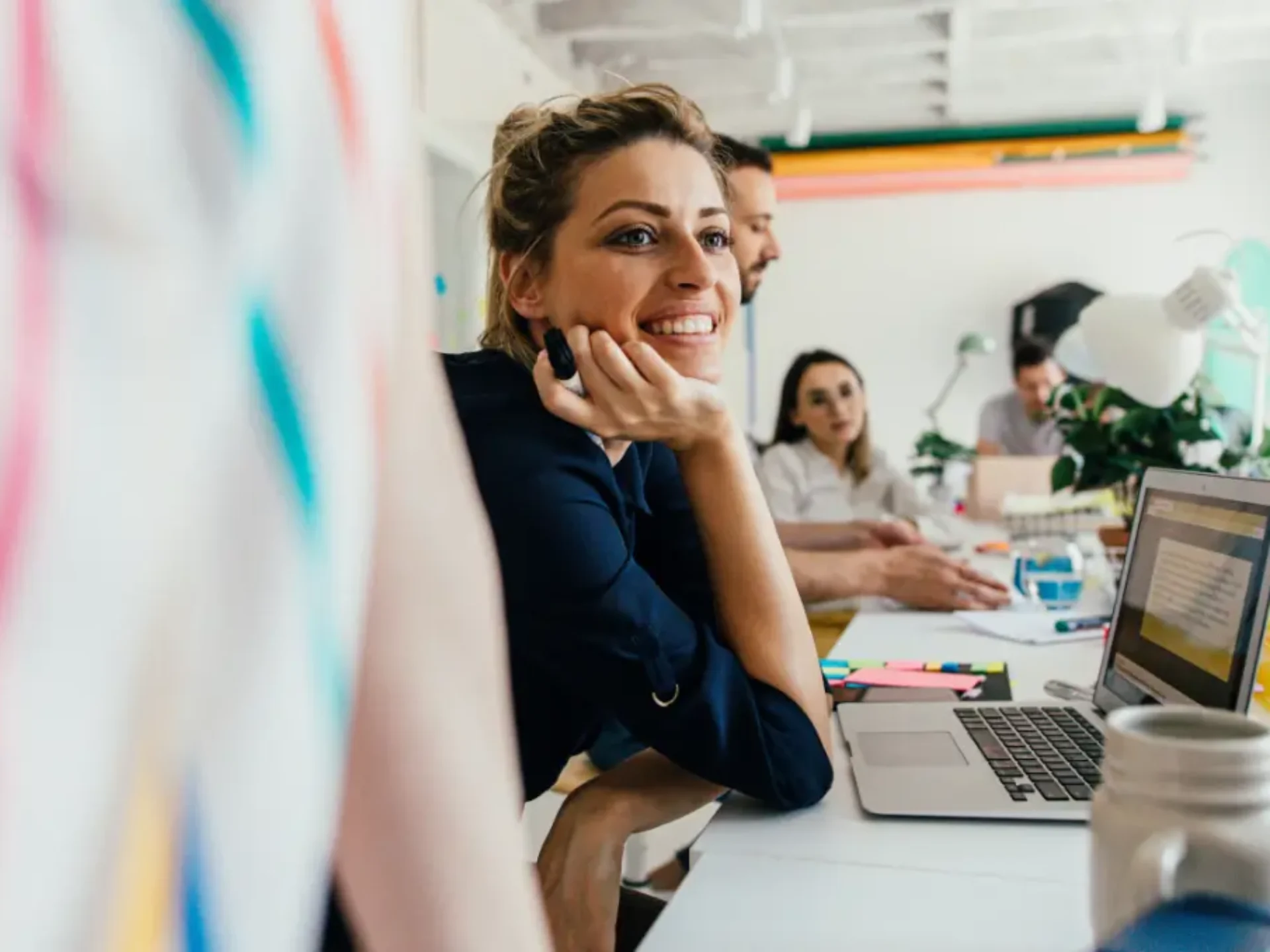 Colleagues working at desks in a bright office