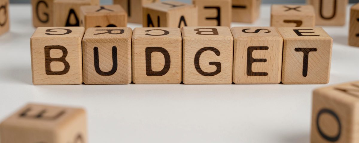 Wooden cubes spelling 'Budget'.