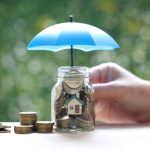 Jar of pennies protected by an umbrella