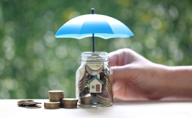 Jar of pennies protected by an umbrella