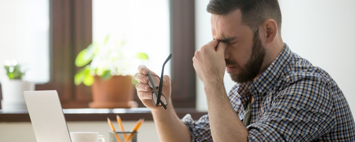 Man looking at laptop stressed