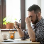 Man looking at laptop stressed