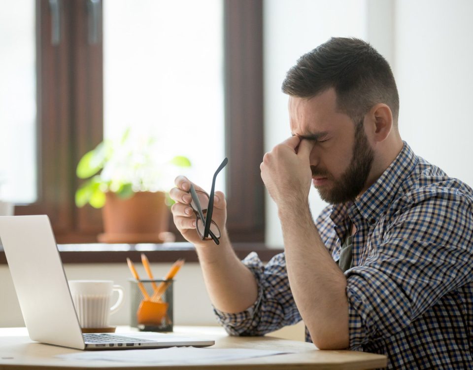 Man looking at laptop stressed