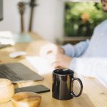 mug-standing-near-working-man